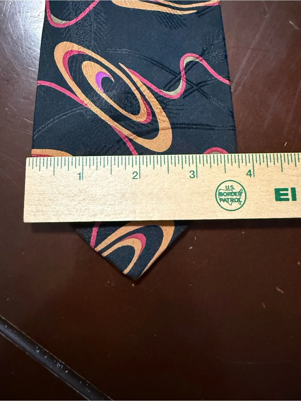 Black Tie with Orange and Pink Orbital Pattern